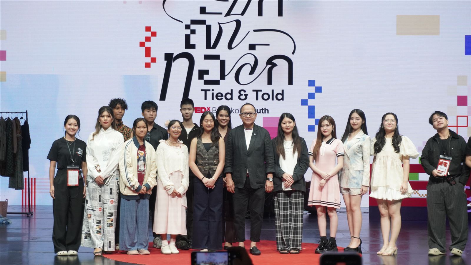 The group photo with speakers and crew under the Tied & Told backdrop